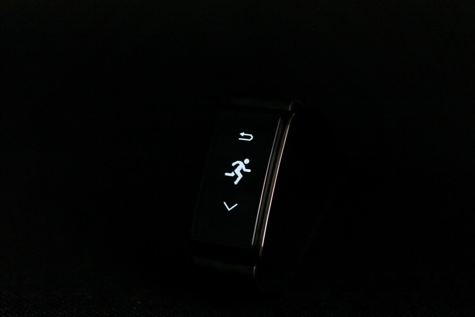 a close up of a watch on a black surface